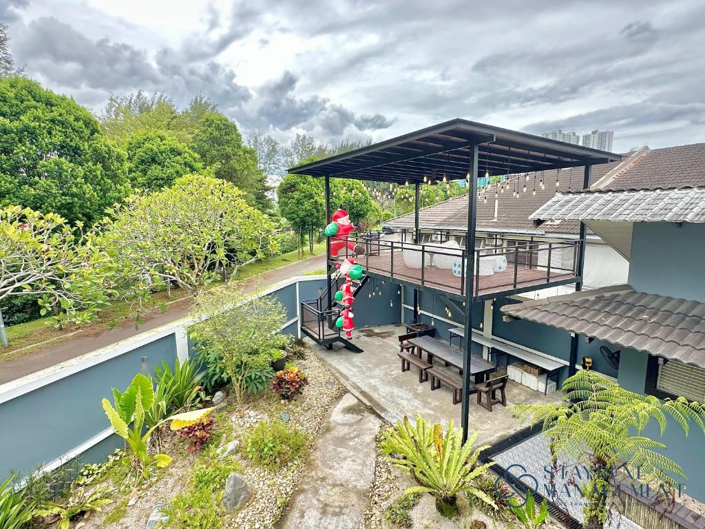 a woman standing on the roof of a house at Mount Austin Landed Homestay 16pax Karaoke Jacuzzi BBQ by Stayrene in Johor Bahru
