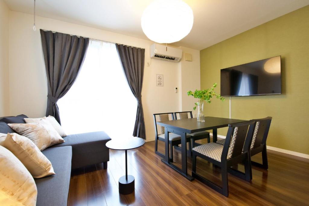 a living room with a couch and a table at Chill Place 125 Kameari in Tokyo