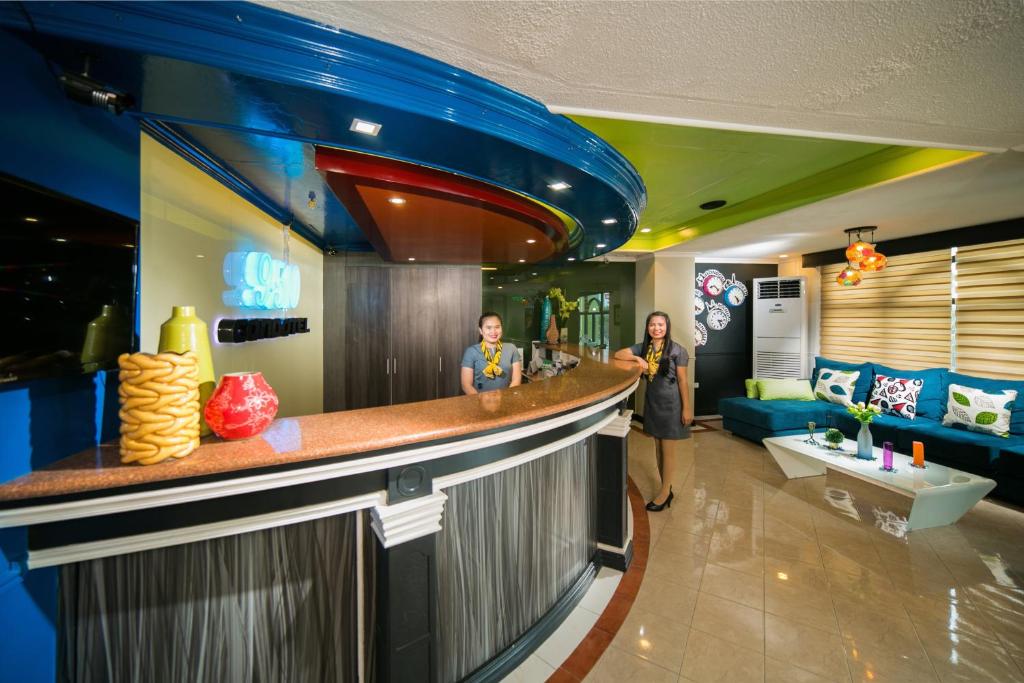 two people standing at a bar in a restaurant at 950 Condotel in Angeles