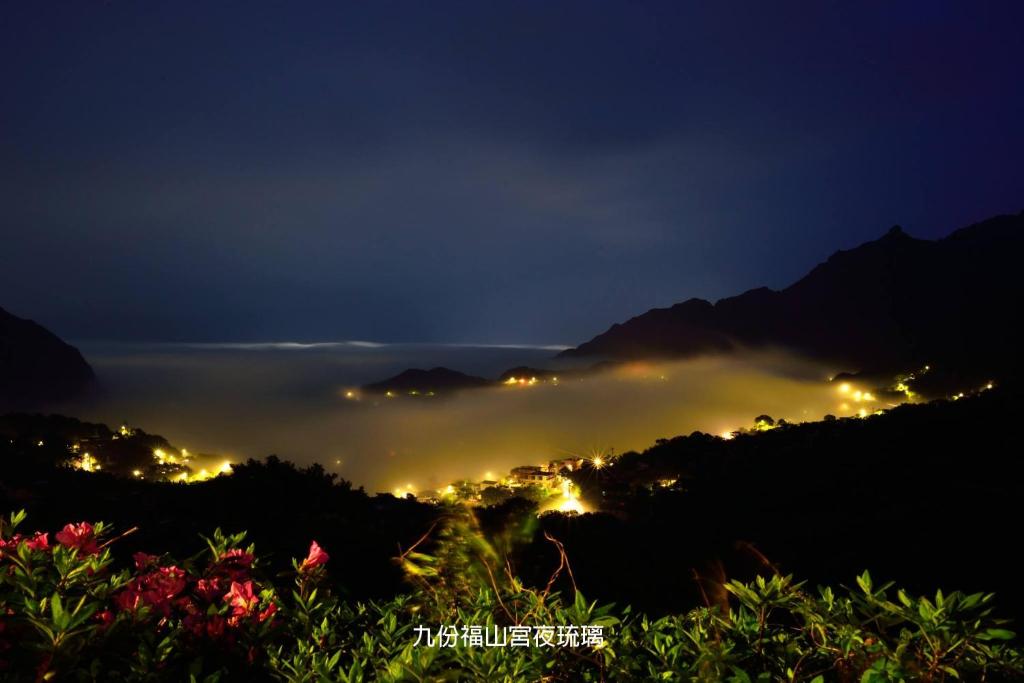 a foggy night with a city in the distance at Blue Sky B&amp;B in Jiufen