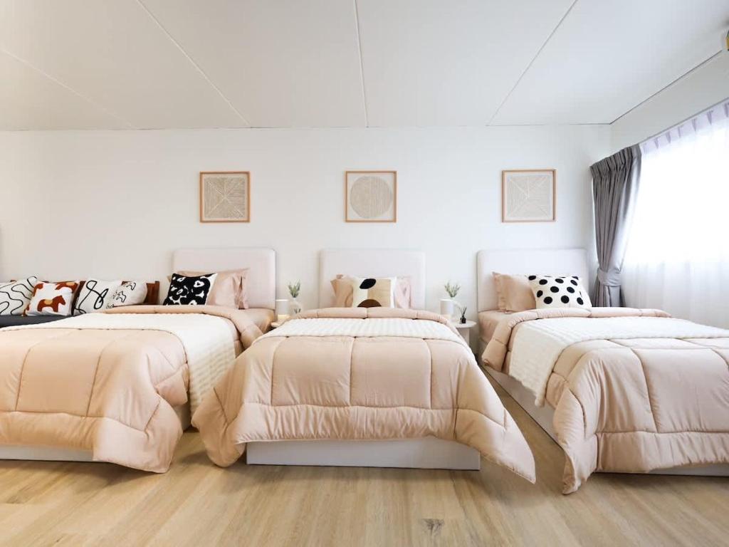 a white room with four beds in it at 3 Beds,WiFi,Washing Machine,IMPACT Arena at T9 in Ban Bang Phang