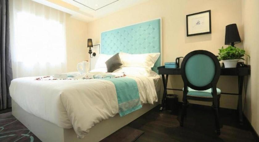 una camera da letto con un letto, una sedia e una scrivania di Xana Lite Beijing Tiananmen Dashilanr Branch a Pechino