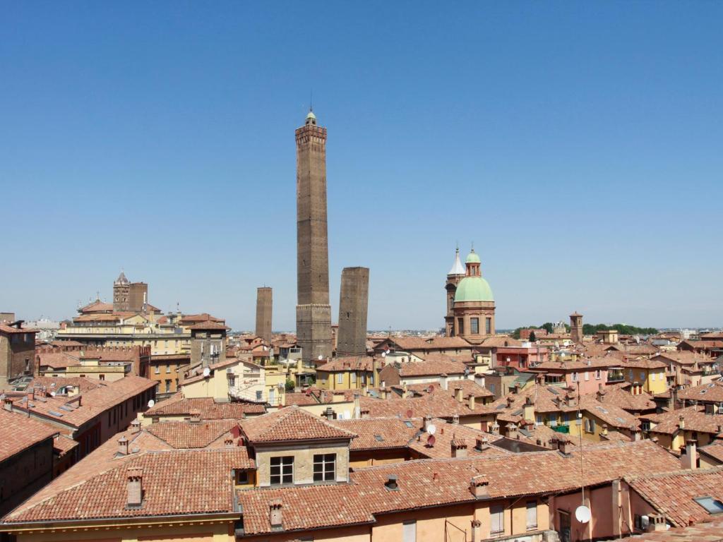 a view of a city with a factory in the background at Casa Isolani - Santo Stefano in Bologna