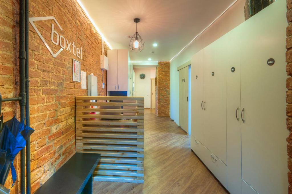 a room with a brick wall and a staircase at Boxtel Hostel in Moscow