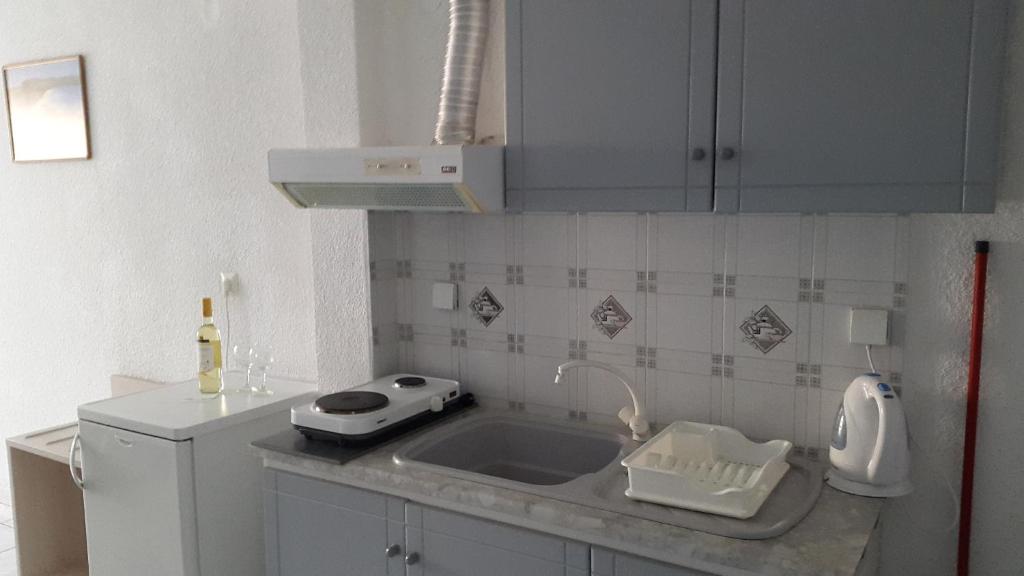 a kitchen with a sink and a counter top at Tassos 2 in Pefkochori