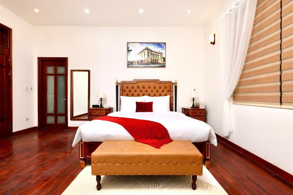 a bedroom with a bed with a red blanket on it at 500m2 Private Villa 2 min to West Lake 7BR in Hanoi
