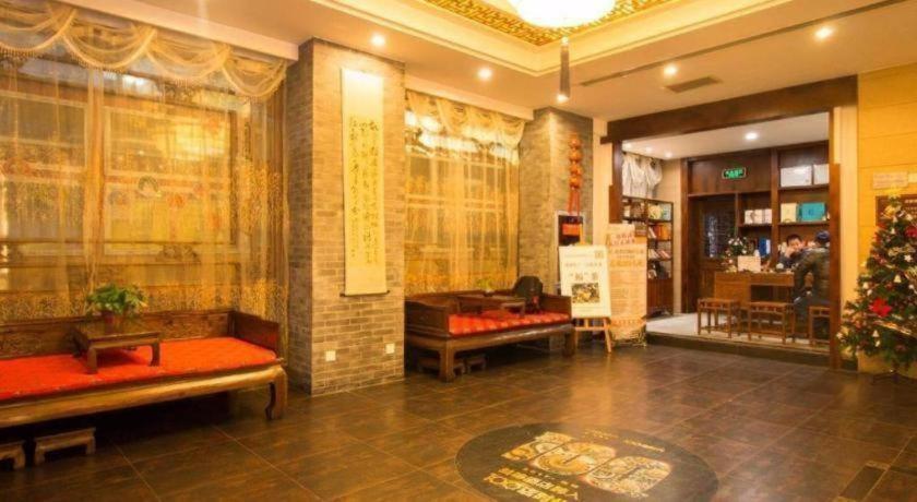 a lobby with benches and a christmas tree in a building at James Joyce Coffetel Xian Dayanta Metro Station Branch in Xi'an