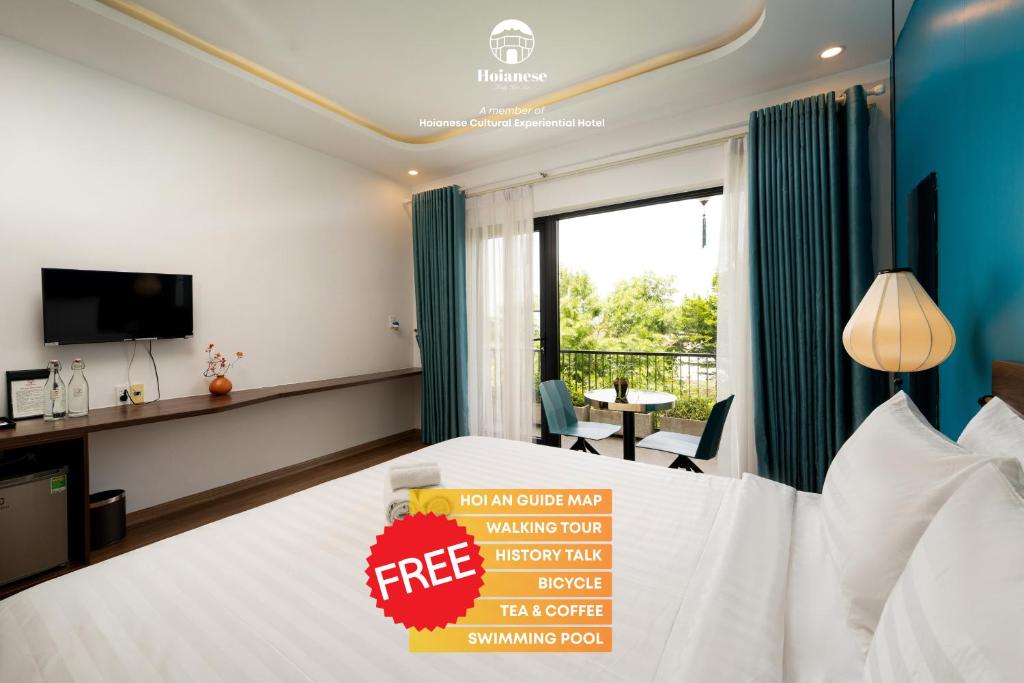 a hotel room with a free sign on a bed at Hoianese Pool & Sunset Hotel - Cultural Experiential Hotel in Hoi An