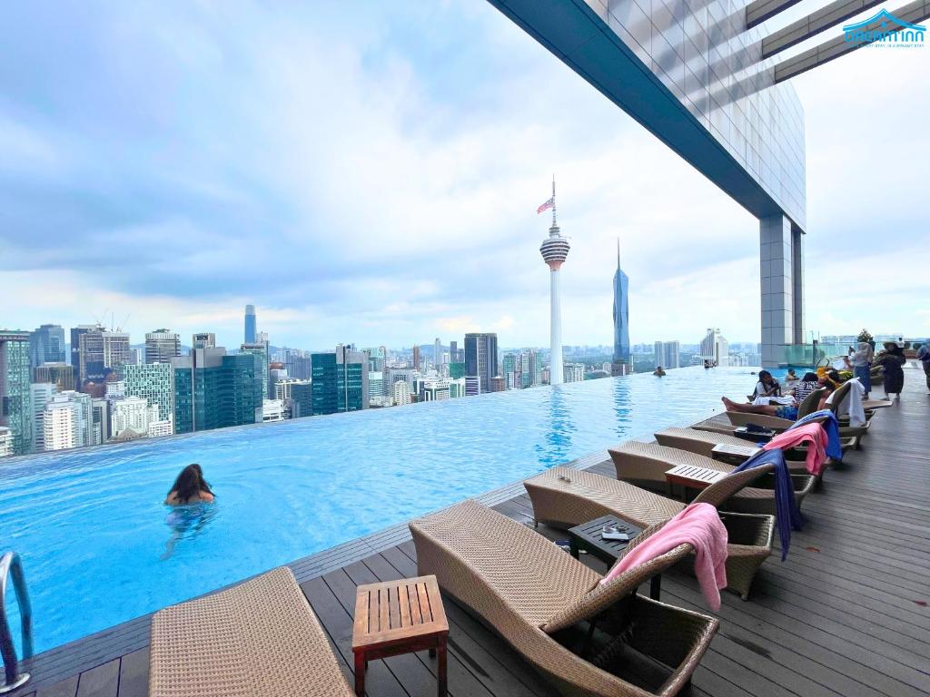a pool on the roof of a building with people swimming at Platinum Suites KLCC by Dream'Inn in Kuala Lumpur