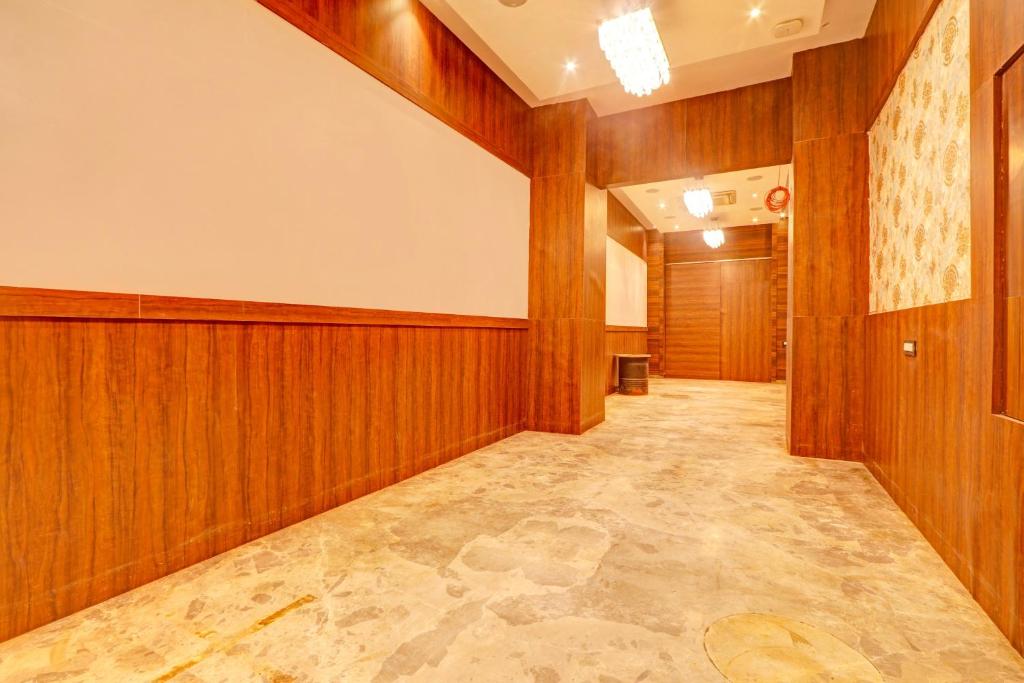 an empty hallway with wood paneled walls and a hallway sidx sidx at Palette Hotel and Resort Zero Mile Sitabuldi Formerly Gangakashi in Nagpur