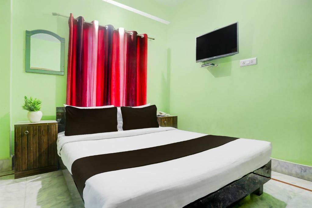 Ένα ή περισσότερα κρεβάτια σε δωμάτιο στο Super Collection O Chhapra Railway Junction Formerly Hotel City Palace