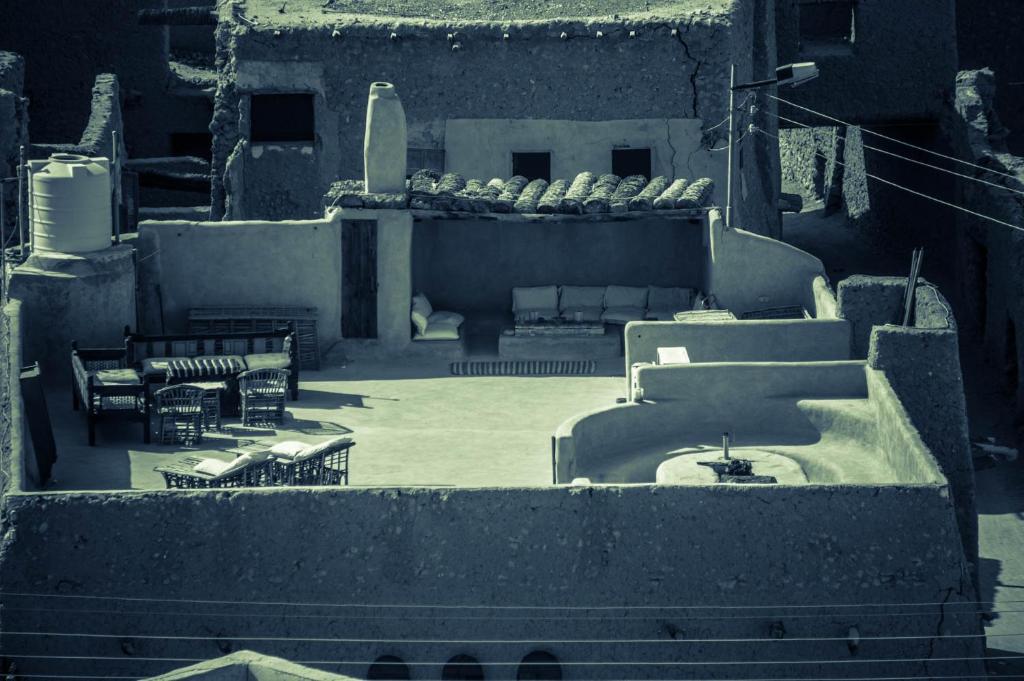 a view of a patio with chairs and a fountain at Siwa Villa in Siwa