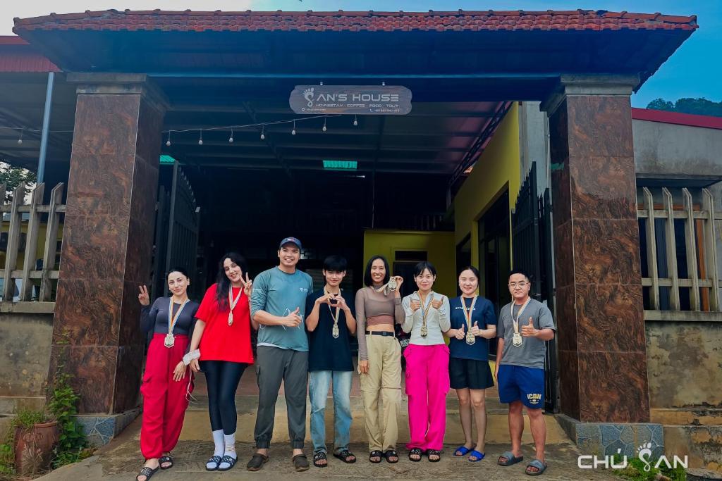 a group of people standing in front of a building at San's House in Hữu Lũng