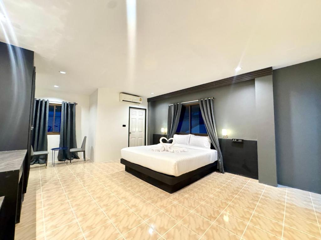 a bedroom with a large white bed in a room at Chapter 26 in Patong Beach