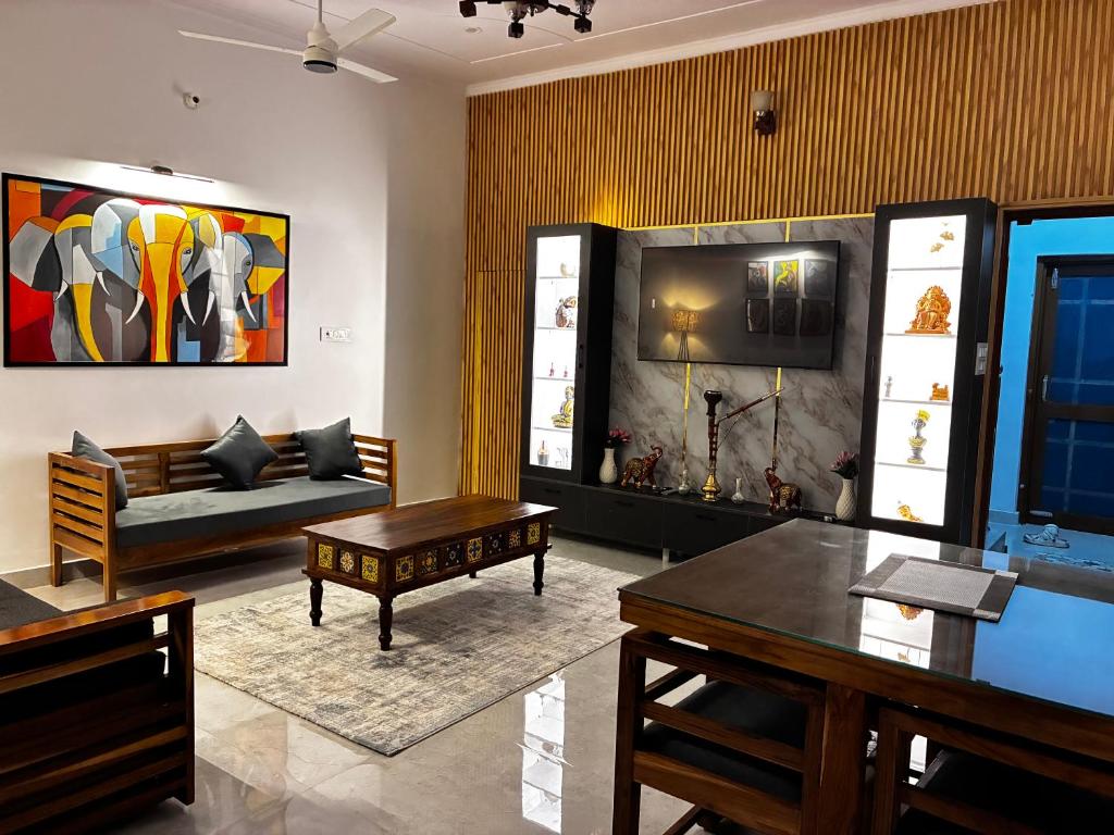 a living room with a couch and a table at Baidehi Cottage in Rishīkesh