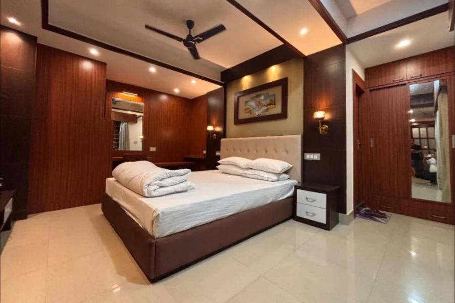 a bedroom with a bed with a ceiling fan at Sacred Grove Homestay in Kalimpong