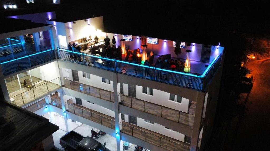 a building with people on a balcony at night at Cuatro Palmas Hotel in Puerto Peñasco