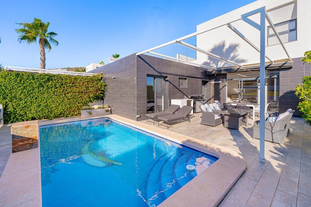 a swimming pool in the backyard of a house at Villa La Finca Golf in Algorfa