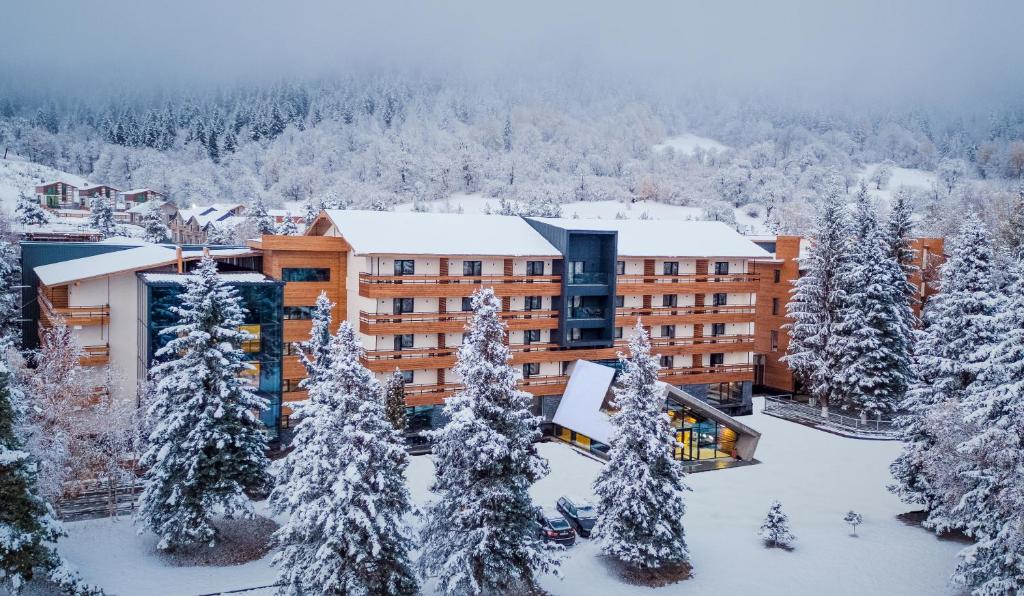 an aerial view of a hotel in the snow at Bakuriani Inn in Bakuriani