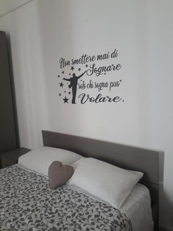 a bedroom with a bed with a wall at dimora princ di napoli 14 in Polignano a Mare