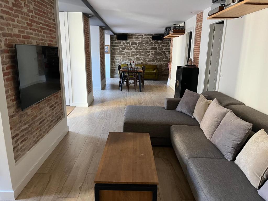 a living room with a couch and a table at Plus in Logroño