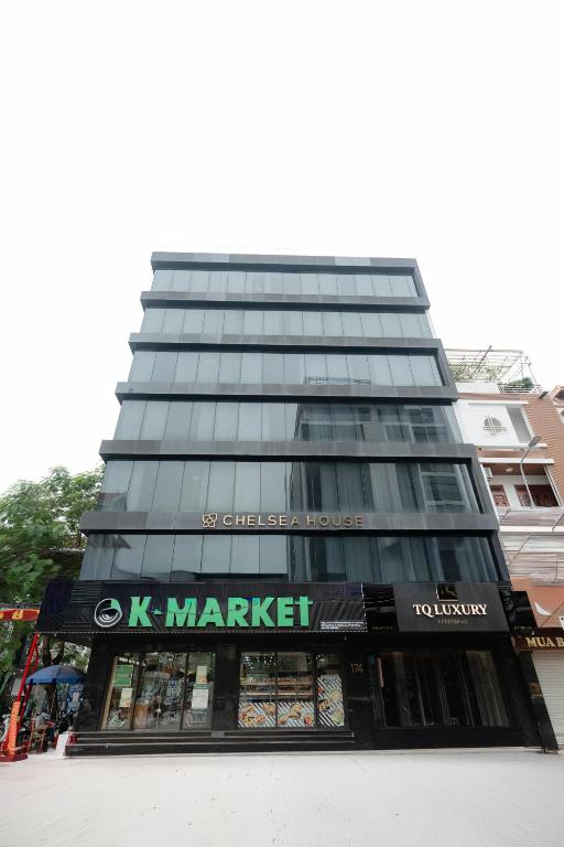 a building with a k market sign in front of it at TQ Luxury Hotel & Apartment in An Khê