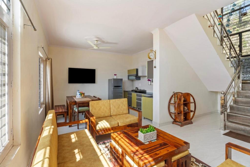 un soggiorno con un divano e un tavolo di Lakeview House 7 mins to Bhimtal Lake3BHK2Bath a Bhimtal