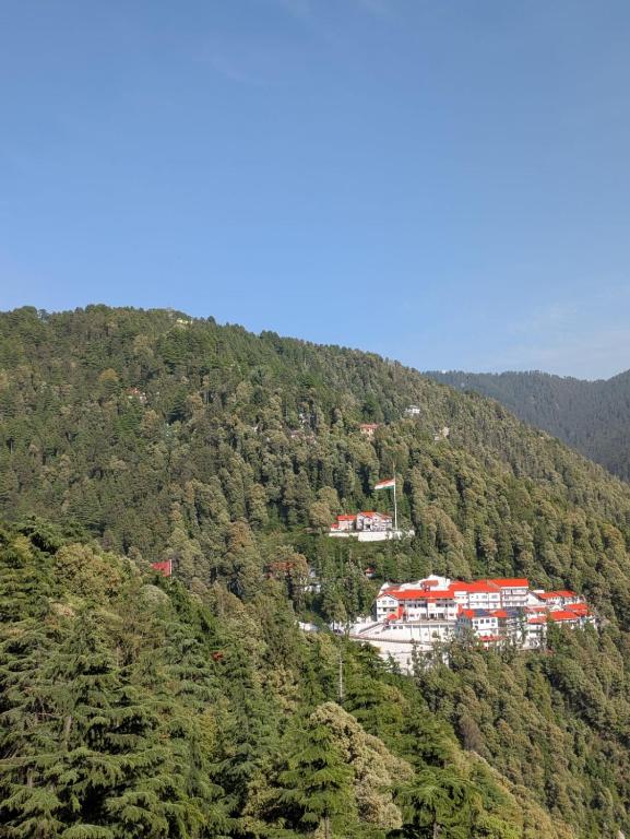 a group of buildings on top of a mountain at Sahil cottage in Chamba