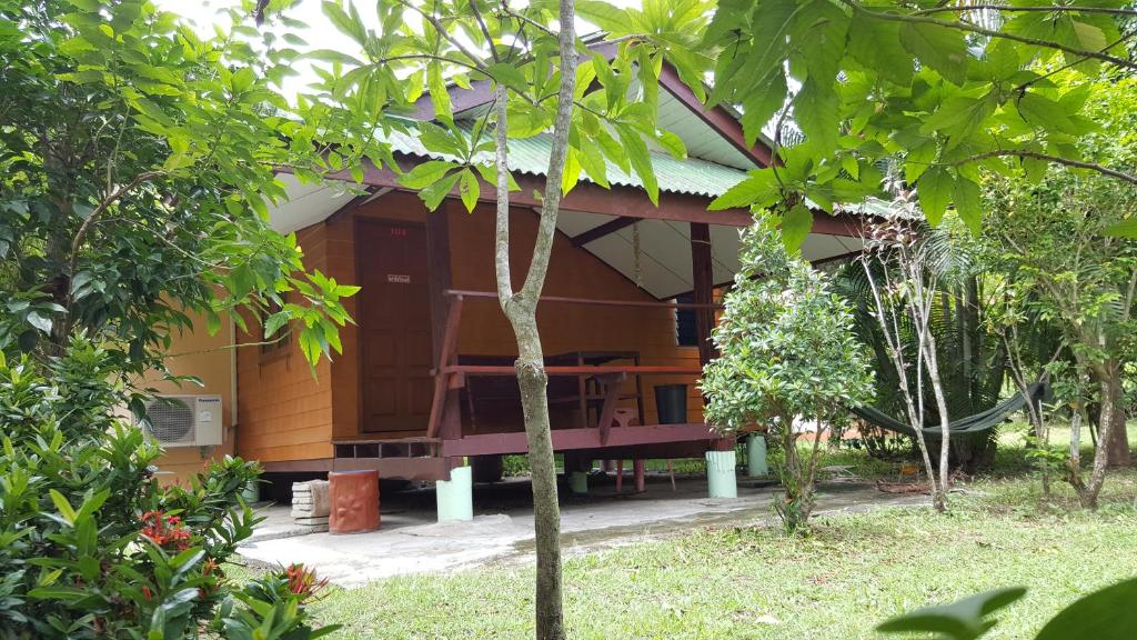 a house in the middle of a forest at Happy Resort in Khanom