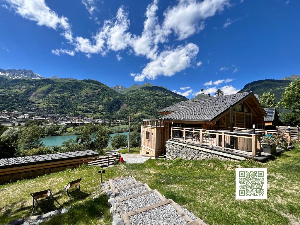 a cabin with a view of a river and mountains at La Grange des Eulets in Bourg-Saint-Maurice