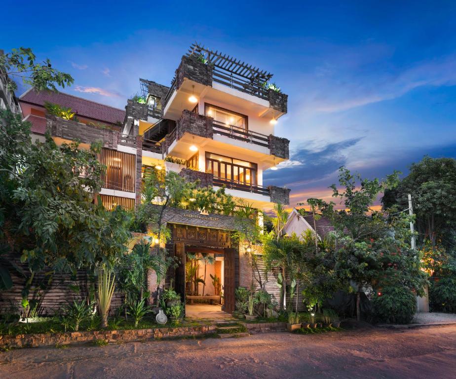 aominium building with a lit up facade at night at Cambana d'Angkor Suites in Siem Reap