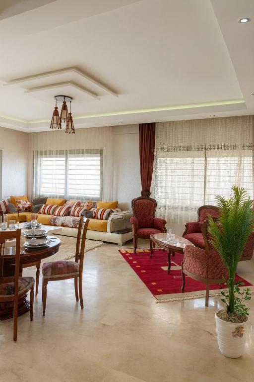 a living room with a couch and a table at 3BR Near Airport Secure,Equipped stay and transit in Nouaseur