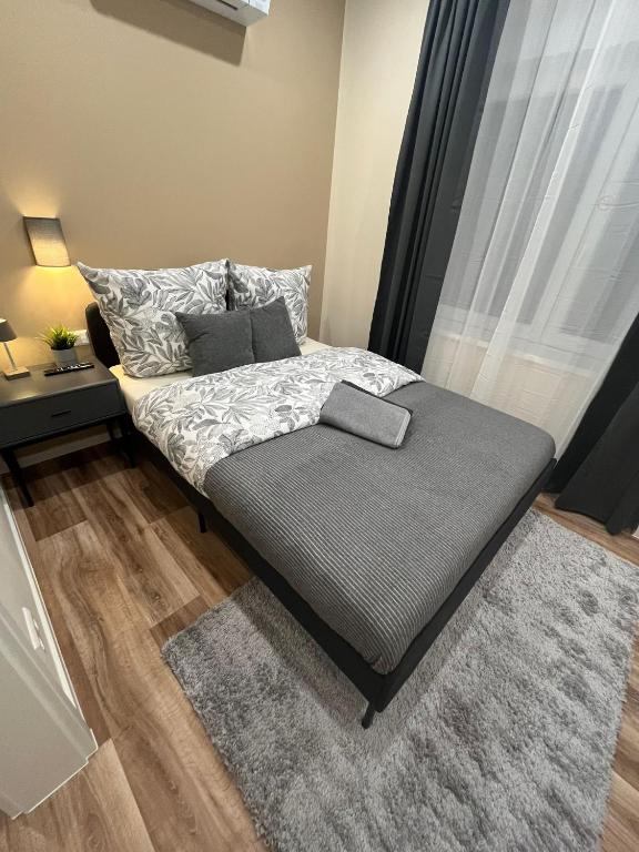 a bed with two pillows and a rug in a bedroom at Live-In Room 5 - Klimatisiert - Coffee for free - in Karlsruhe