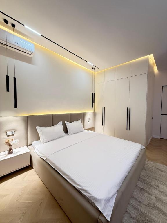 een slaapkamer met een groot bed en een witte kast bij Altair in Simkent