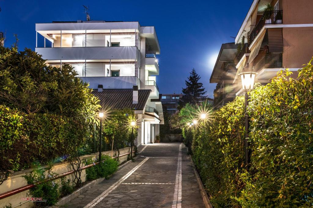 an empty street in front of a building at night at Hotel Villa Giulia in Ciampino