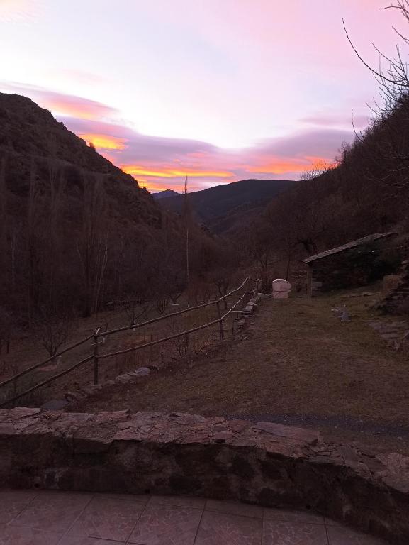 a sunset in the mountains with a wooden fence at Ecogite du Mas de Trape in Talau