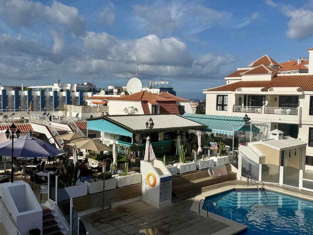 a view of a resort with a pool and buildings at Cindy Golden Bay SeaView Terrace in El Guincho
