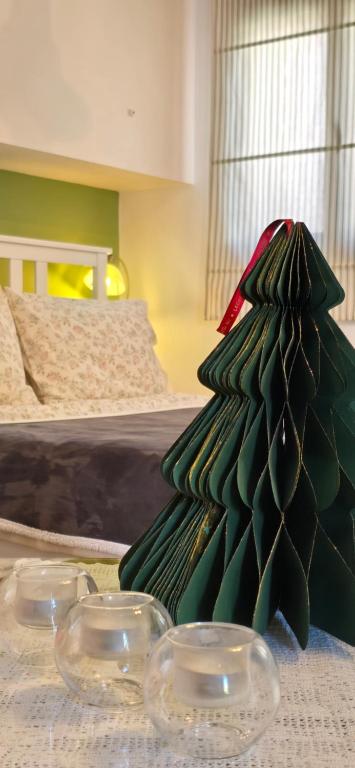 a green plastic christmas tree sitting on a table at BaSiLiKoS in Perdhika