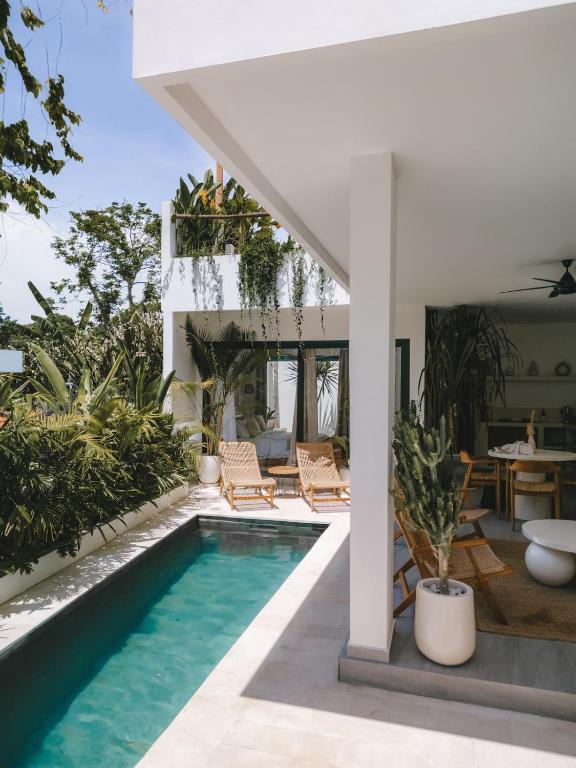 a swimming pool in a villa with a house at Private 1 bedroom villa with rooftop and pool in Tumbak Bayuh