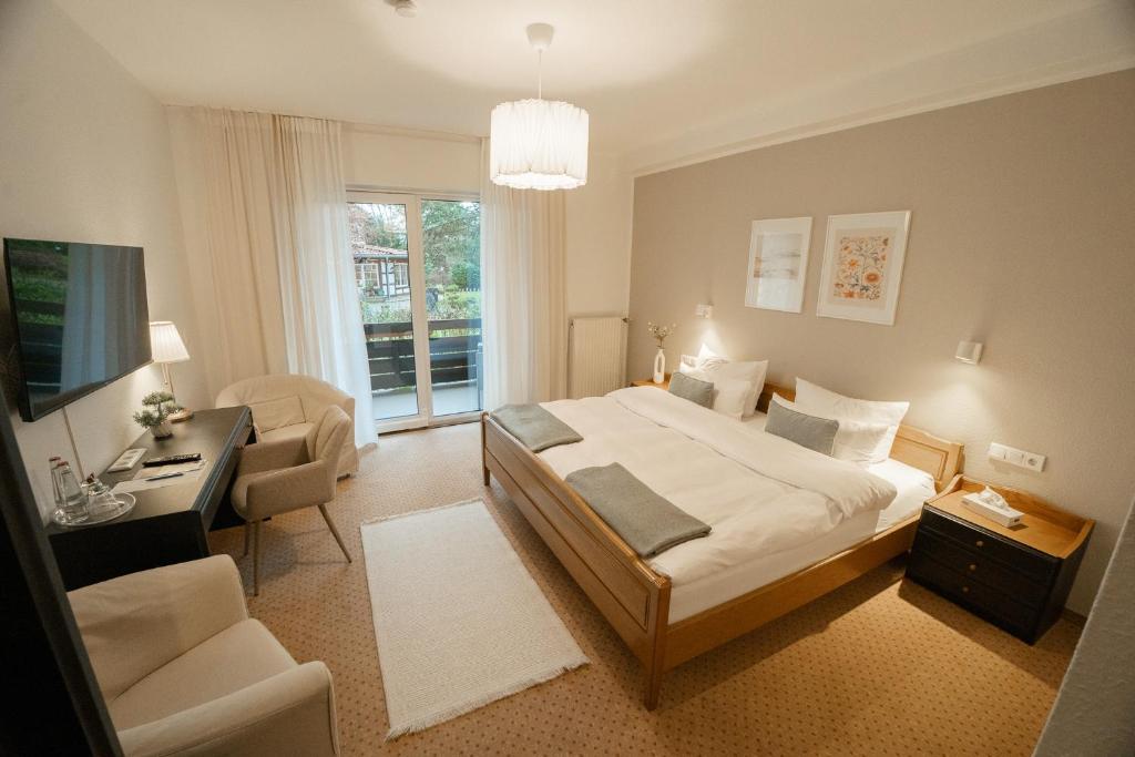 a bedroom with a bed and a desk and a television at The Resting Place in Lemgo