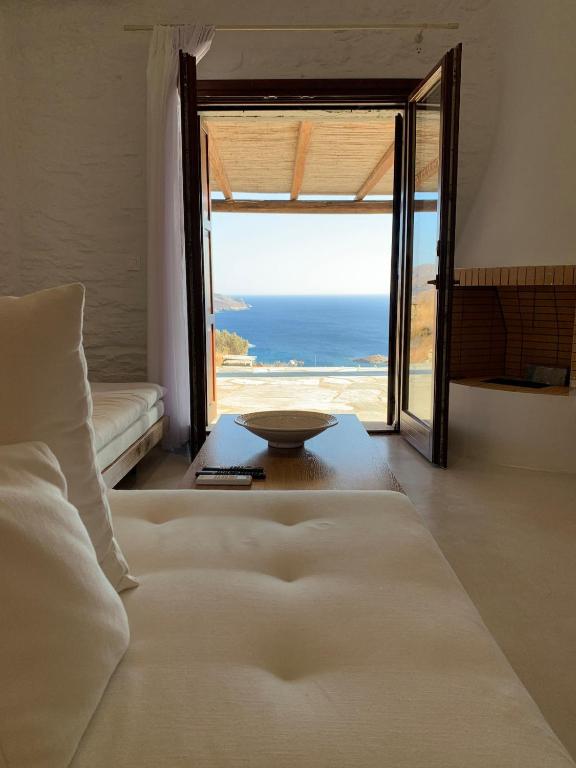 a bedroom with a bed and a view of the ocean at Conte Kea in Koundouros