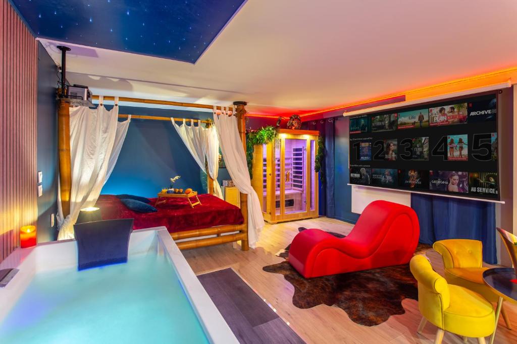 a room with a bed and a table and chairs at Twilight Star Spa - Sauna & Private Cinema - Free Parking in Amiens