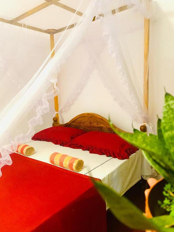 a red and white bed in a white tent at Perfect Home Mirissa in Mirissa