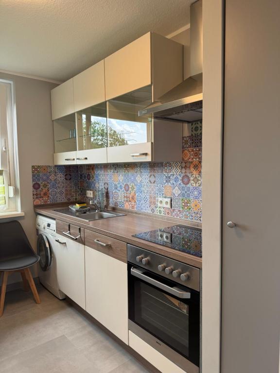 a kitchen with a sink and a stove top oven at ZV38-Mammut-3 in Salzgitter