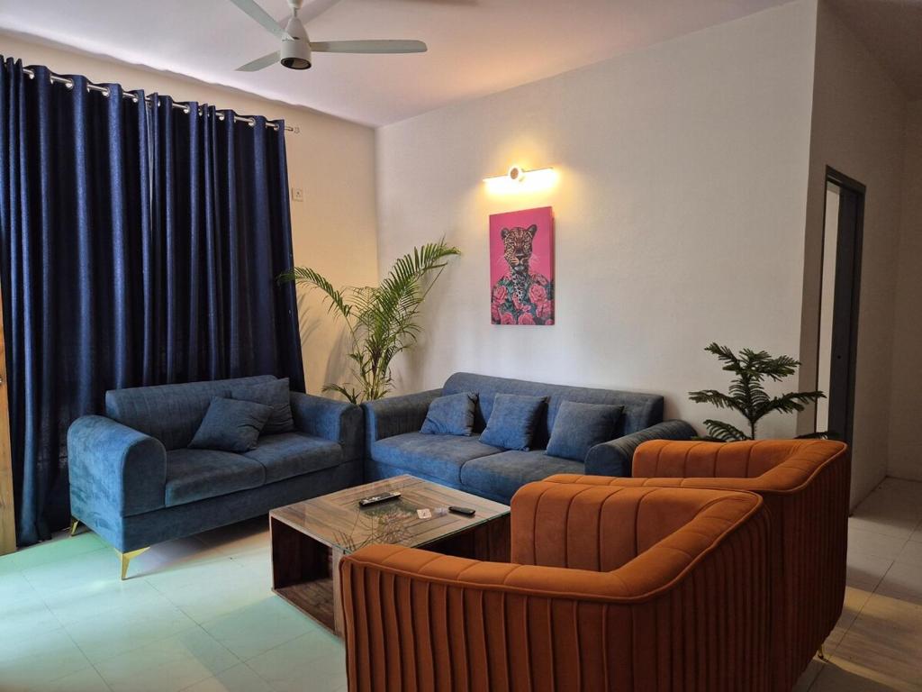 a living room with two couches and a table at The Palm Villa in Jaipur