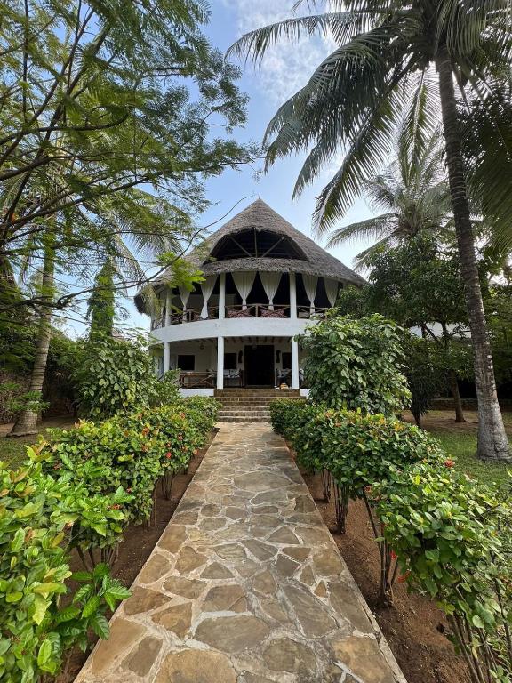 a large white building with a pathway leading to it at Kitu Sawa Sawa in Watamu