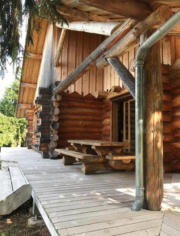 a log cabin with a porch and a deck at Chalet canadien en Morvan in Rouvray