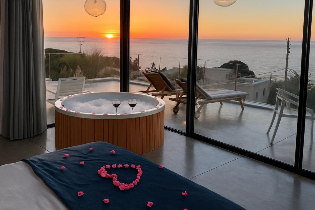 a room with a hot tub and a view of the ocean at Casa de Thoum in Batroûn