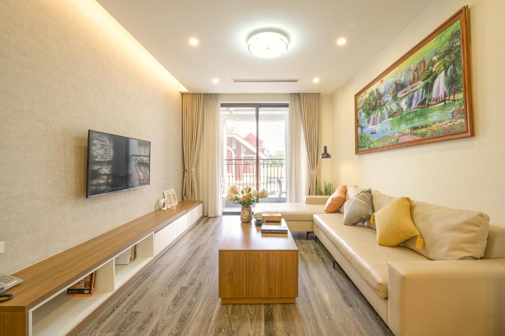 a living room with a couch and a table at Duc Hoang Residence & Hotel West Lake in Hanoi