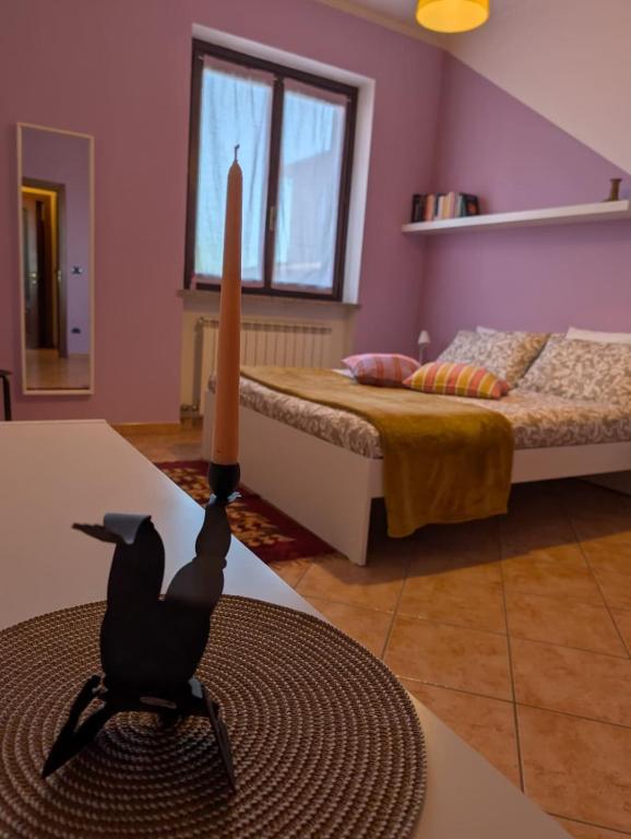 a bedroom with a bed and a candle on a table at Appartamento Albachiara in Revello